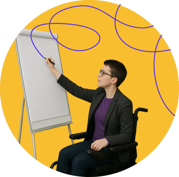 photo of a person who uses a wheelchair writing on a flip chart