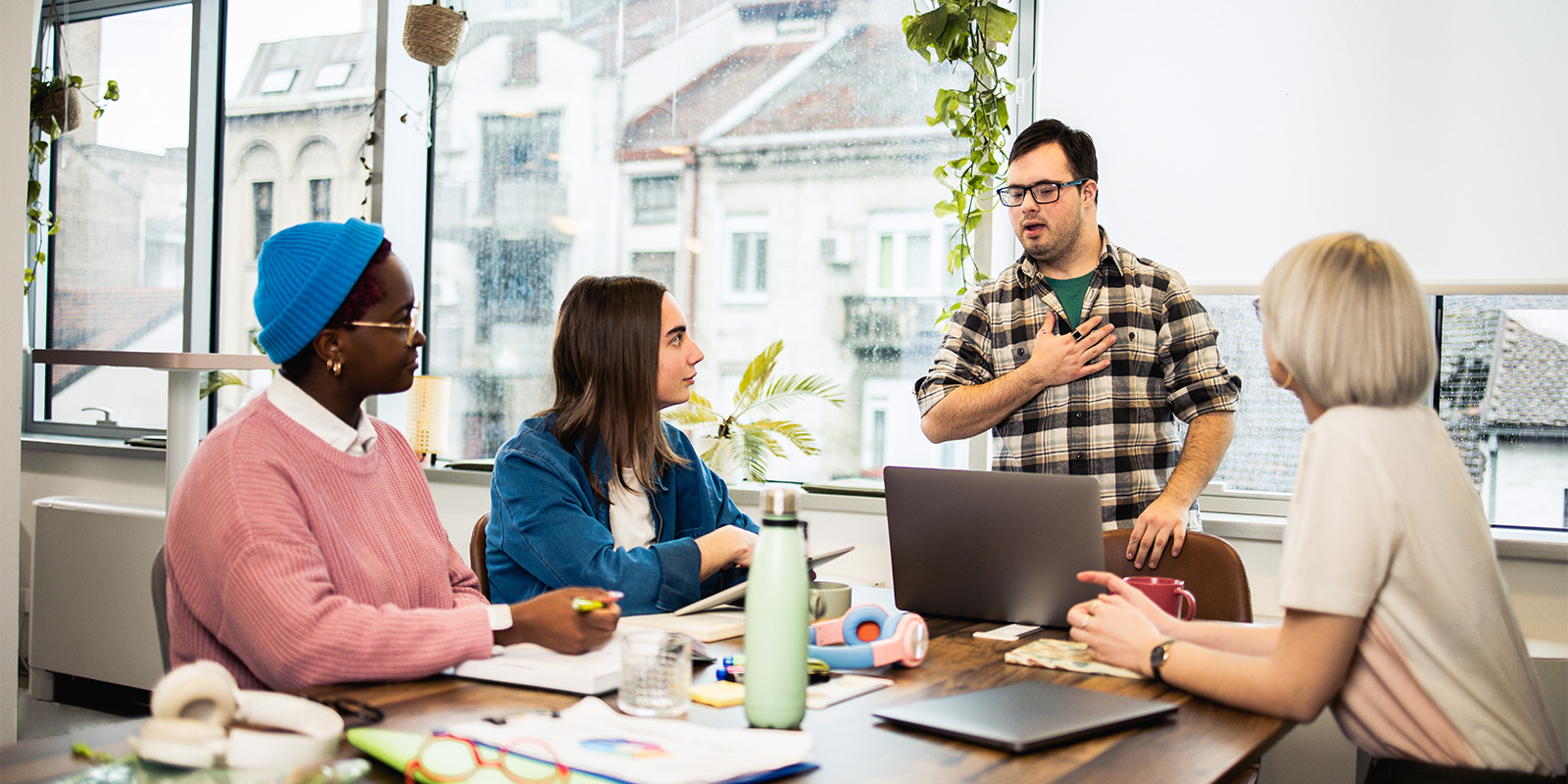 Young man presenting a business project to his diverse business team