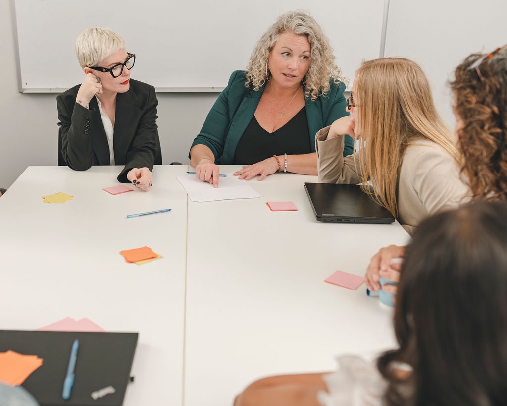 A group of disabled and non-disabled people meeting around a table.